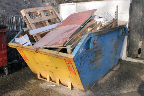 Professional garage clearance team organizing a cluttered garage in Brixton